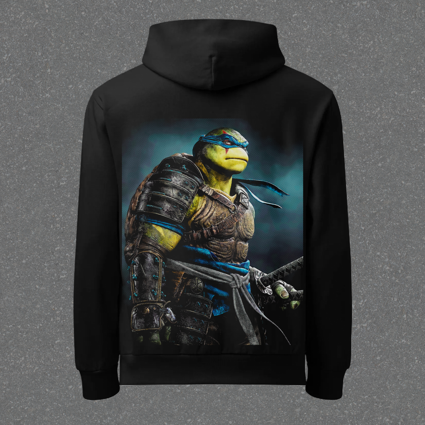 Black hoodie with a turtle character design on the back against a gray background