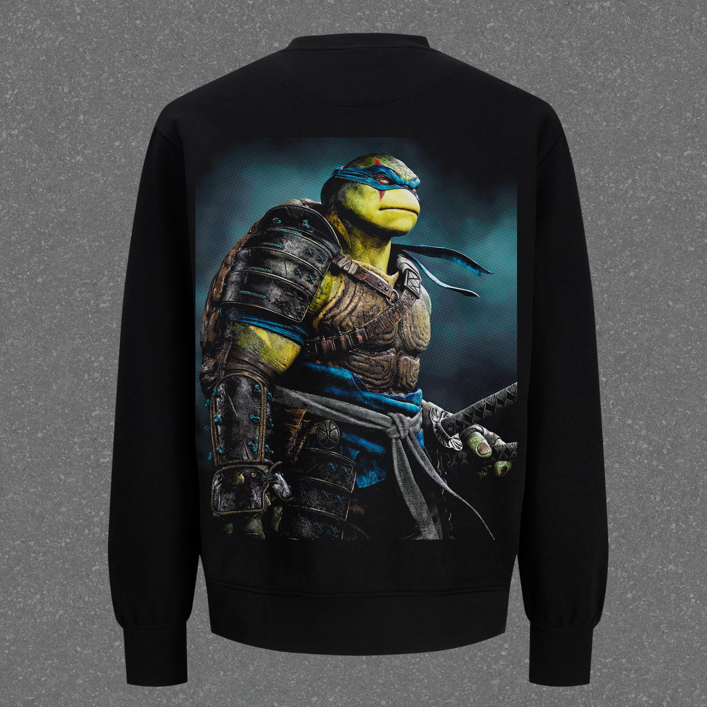 Black sweatshirt with a graphic of a turtle character on the back against a gray background